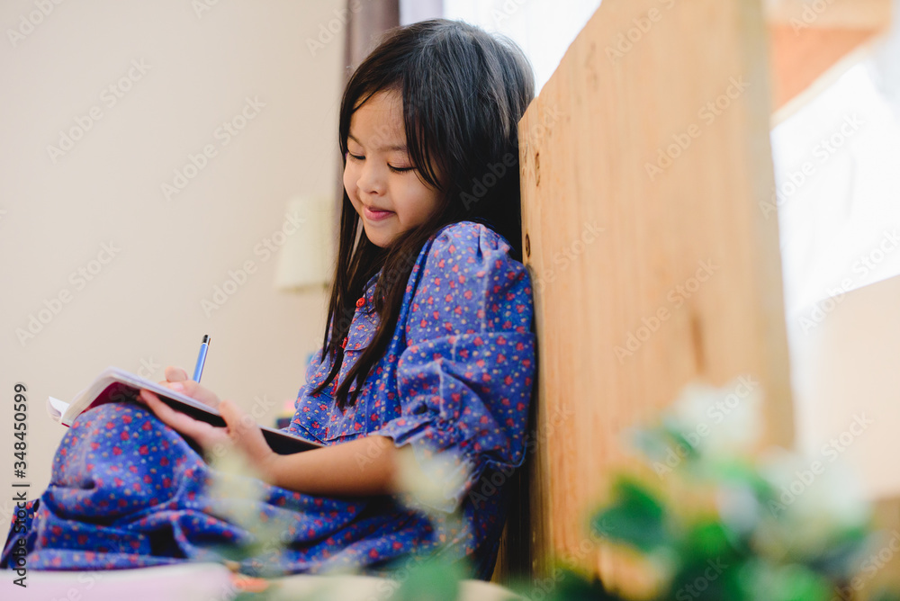 Girl doing homework, kid writing paper, education concept, back to school, stay home Girl doing homework, kid writing paper, education concept, back to school, stay home
