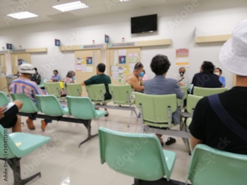 patient in hospital,  waiting to see a doctor and hospital service .. sitting spaced between people to stop the spread of the virus Covid-19.