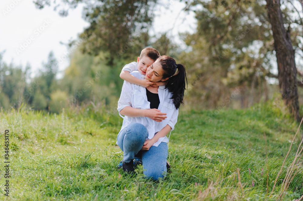 Happy family! Mother with son child playing having fun together on the grass in sunny summer day, life moment Happy family! Mother with son child playing having fun together on the grass in sunny summer day, life moment