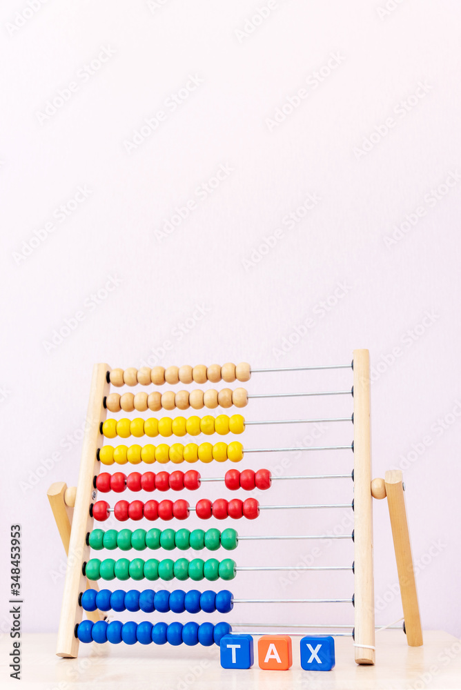 Tax Concept with tax word from plastic blocks and childs bright scores Tax Concept with tax word from plastic blocks and childs bright scores