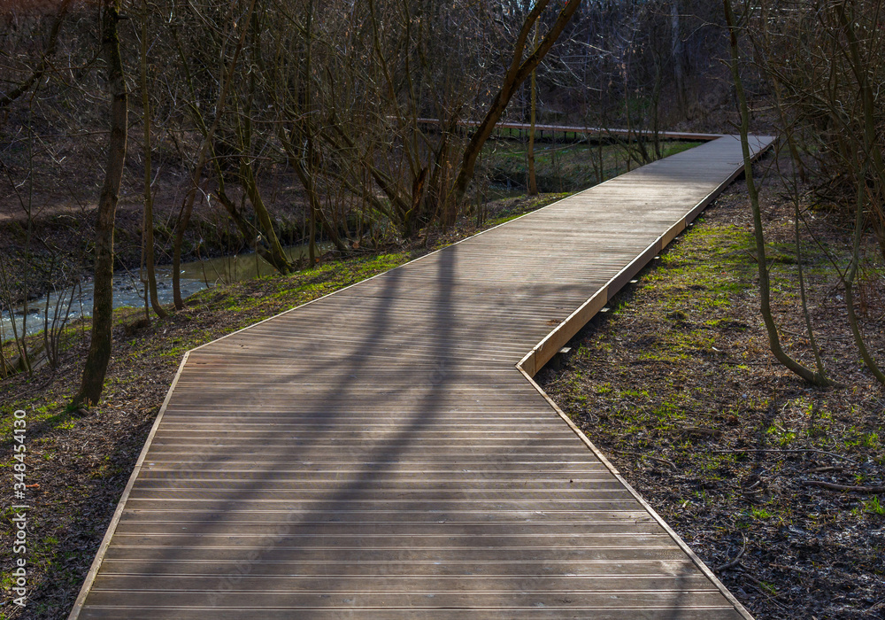 Park path along Ochakovka river in early spring, Western Administrative District, Moscow, Russia Park path along Ochakovka river in early spring, Western Administrative District, Moscow, Russia