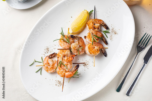 grilled shrimp on a white plate in a restaurant