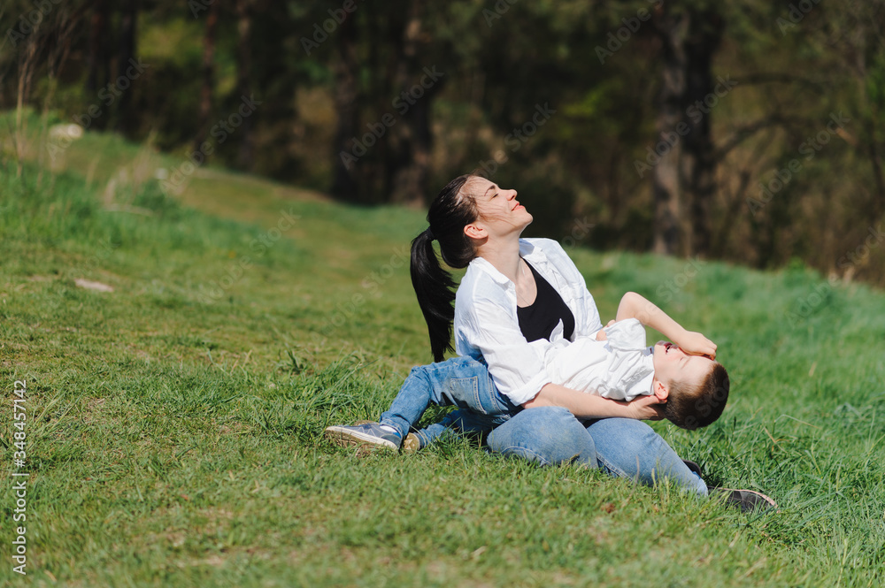 Stilish mother and handsome son having fun on the nature. Happy family concept. Beauty nature scene with family outdoor lifestyle. Happy family resting together. Happiness in family life. Mothers day. Stilish mother and handsome son having fun on the nature. Happy family concept. Beauty nature scene with family outdoor lifestyle. Happy family resting together. Happiness in family life. Mothers day.