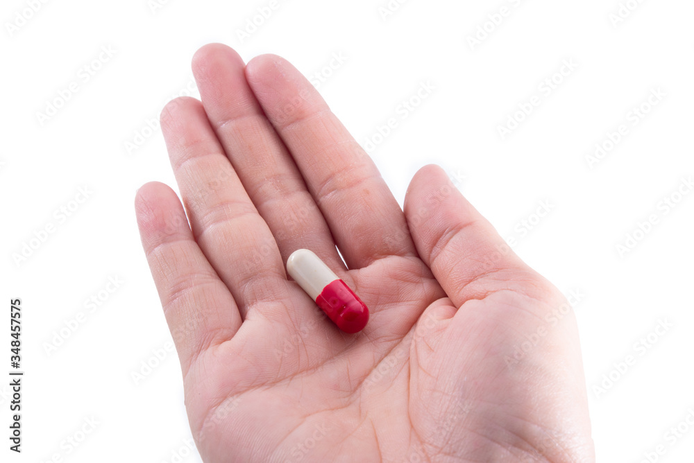 Multicolored pills in a white bottle, isolated on a white background. Multicolored pills in a white bottle, isolated on a white background.