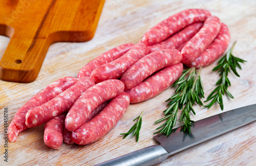 Raw meat sausages  for frying on wooden desk