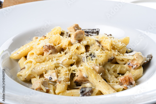 Traditional authentic italian penne al pollo e funghi pasta with mushroom ,chicken, parmesan cheese.