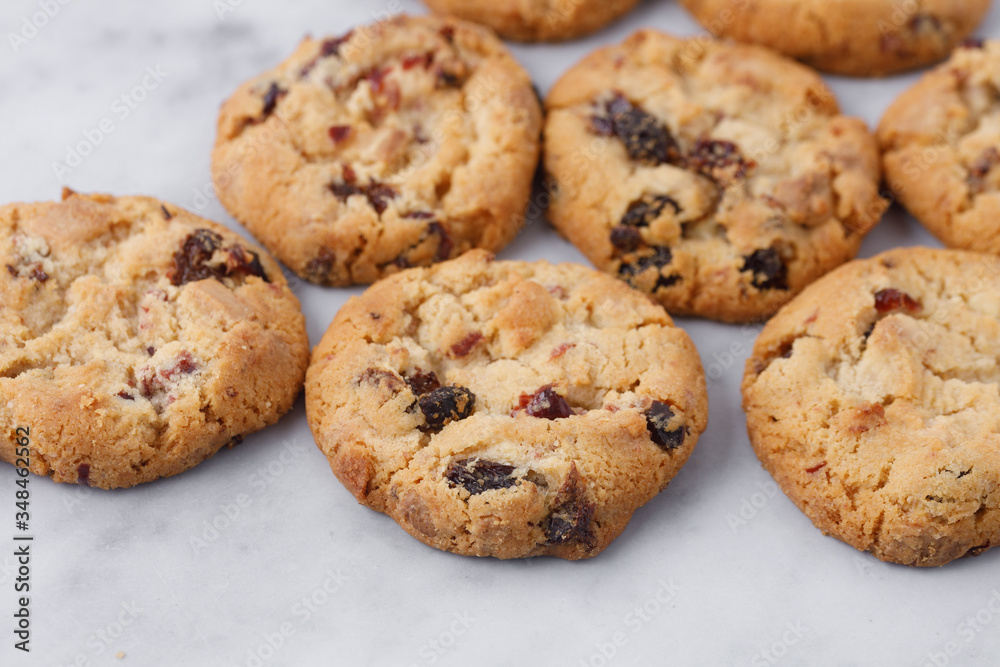 Homemade cranberry cookies on marble background, close up.