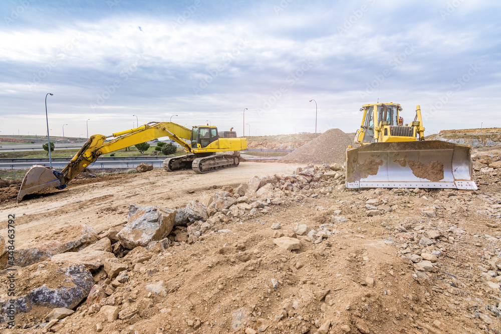 Excavator moving stone and rock at a construction site Excavator moving stone and rock at a construction site
