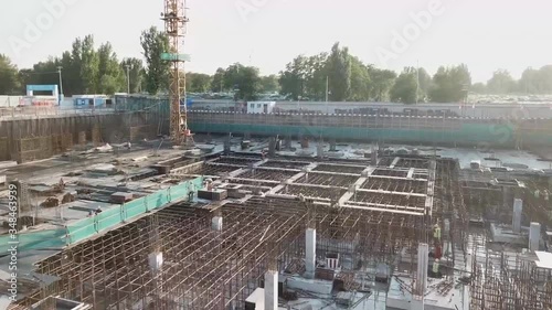 BEIJING, CHINA - Construction cranes are seen in front of new terminal of Beijing Daxing International Airport. Aerial view of the construction of hotel complexes near the airport. photo