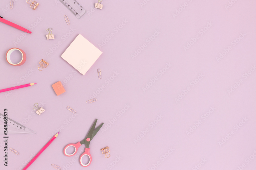 Top view of various stationery on a purple pastel background. Back to school concept with copy space. Top view of various stationery on a purple pastel background. Back to school concept with copy space.