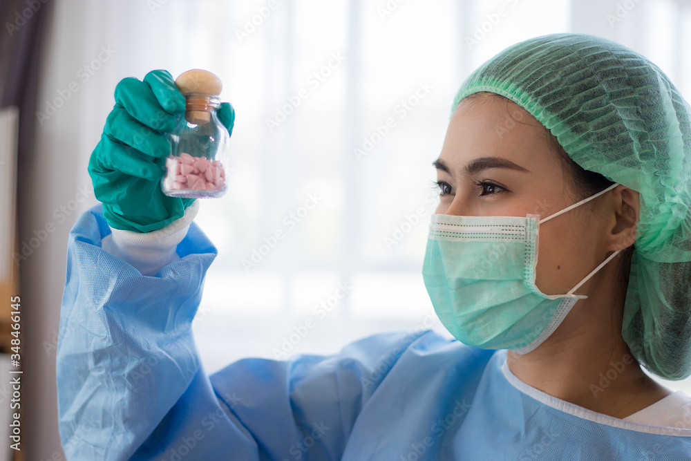 Corona virus, or Covid-19, is spreading all over the world.Asian girls scientist works in modern biological lab, Covid-19 is currently trying to find a drug against the virus to treat the infected.