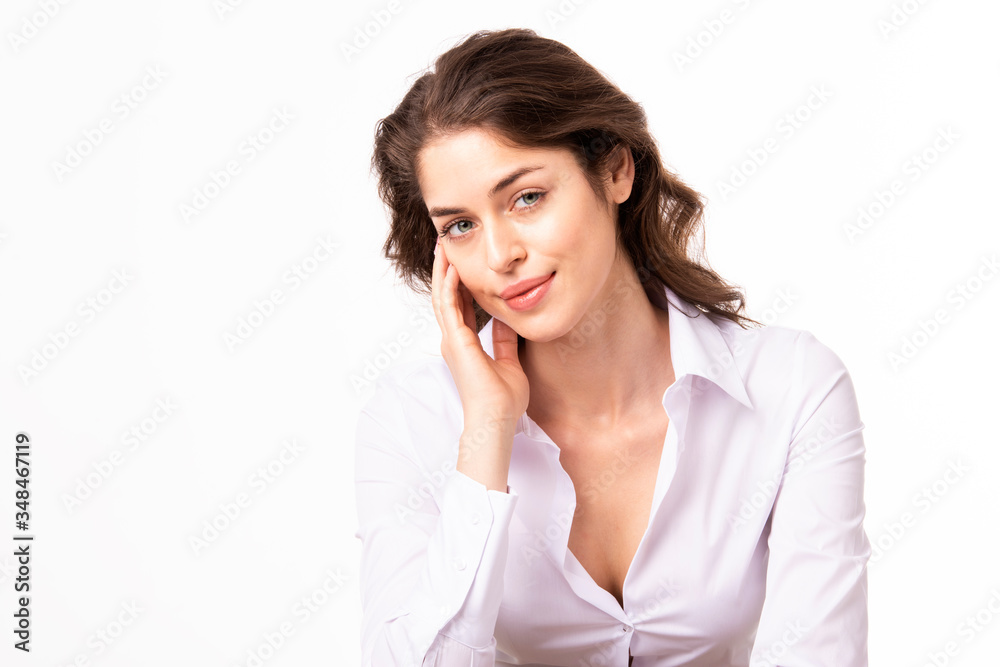 Close-up portrait shot of beautiful young woman sitting at isolated white background while looking at camera and smiling. Close-up portrait shot of beautiful young woman sitting at isolated white background while looking at camera and smiling.