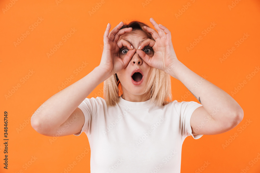 Image of surprised attractive woman grimacing and gesturing ok sign Image of surprised attractive woman grimacing and gesturing ok sign