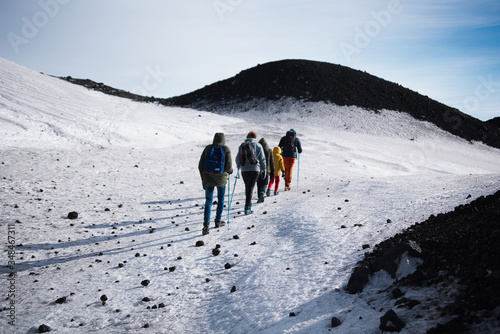Family walking on snowy volcano mountain