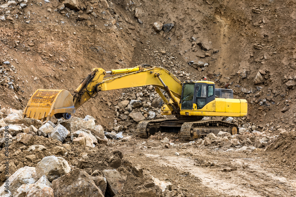 Heavy machinery moving stone and rock in an open mine Heavy machinery moving stone and rock in an open mine