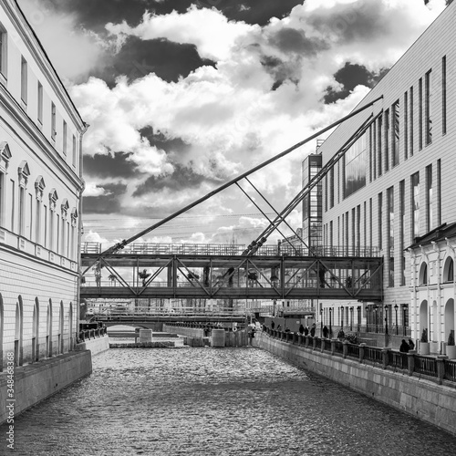 black and white photo of the suspension bridge over the canal between the buildings of the Mariinsky Theater in St. Petersburg, Russia photo