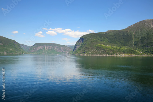 Beautiful landscape in the fjord, with reflections of the mountains in the water. Peace & tranquility, Rosendal, Hardangerfjord, Norway.