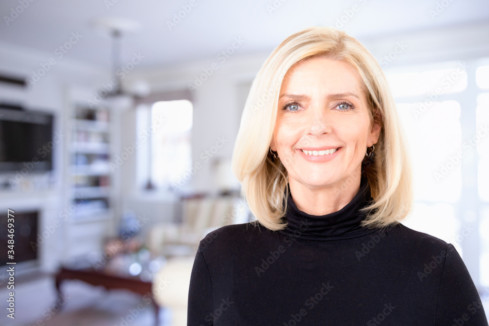 Beautiful mature woman portrait while standing in the living room Beautiful mature woman portrait while standing in the living room