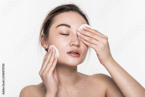 Young attractive asian woman beauty use sponge isolated on white background