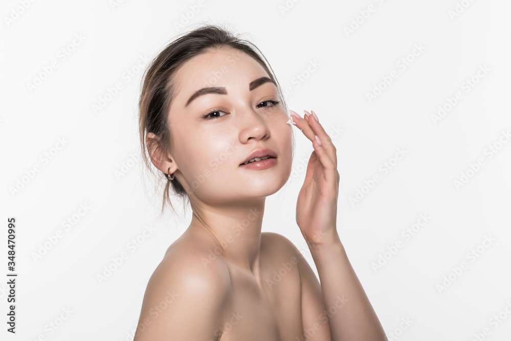 Beautiful asian woman washing her beauty face with cleansing foam on her hands for skin care isolated on white background