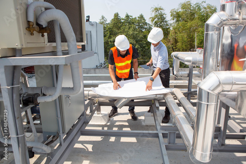 Engineers are checking the air cooled chiller, located on the roofs of the building.