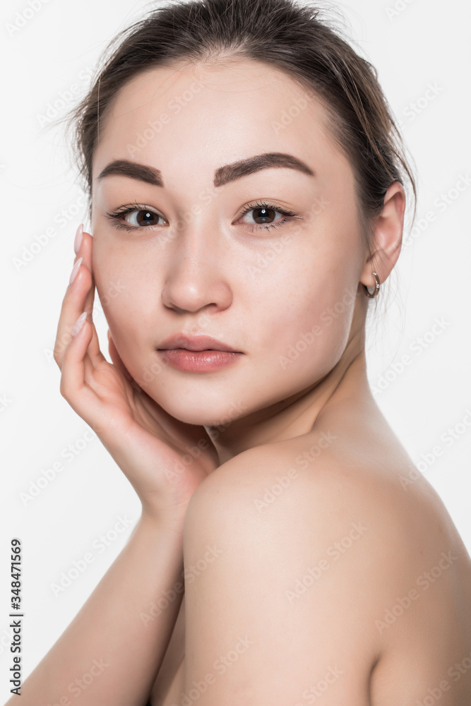 Beautiful face of a young woman with clean fresh skin isolated on white background. Skincare and body care concept.