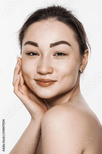 Beauty asian woman with clean fresh skin isolated on white background. © dianagrytsku