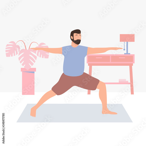 Man doing yoga at home during pandemic of coronavirus. Home yoga exercise practice and meditation. Healthy lifestyle and relaxing time at home.