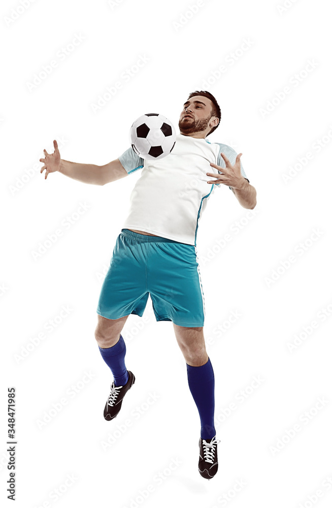 Fototapeta premium Young man playing football on white background