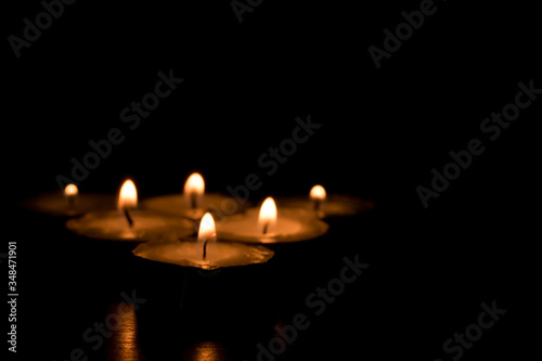 Blurred candles that are lit in the dark