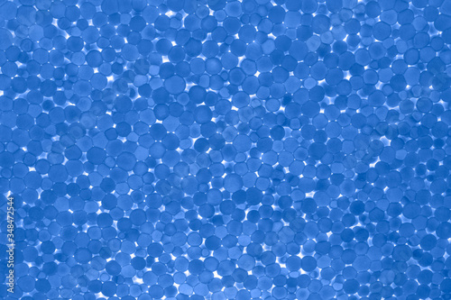 Blue backlight surface with low backlight, closeup. Abstract background, texture.