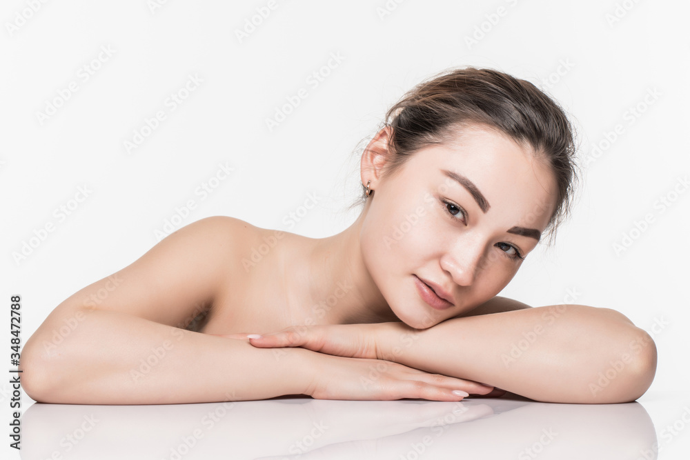 Charming asian woman face while lying isolated on white background Charming asian woman face while lying isolated on white background