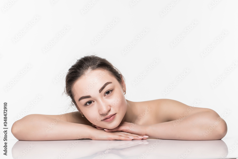 Beautiful face skincare beauty asian woman lying down with mirror reflection isolated on white background. Beautiful face skincare beauty asian woman lying down with mirror reflection isolated on white background.
