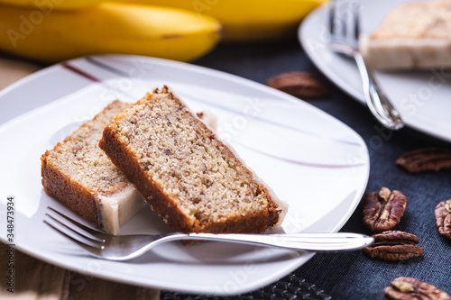 Piece of banana cake on white plate