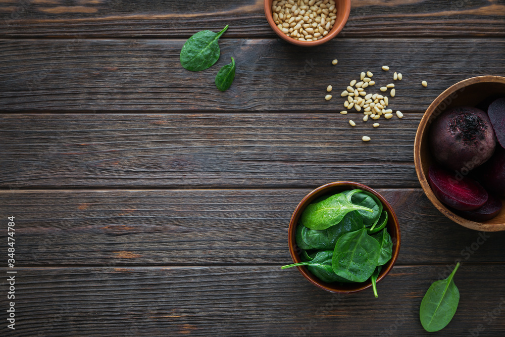Healthy breakfast with boiled beetroot, baby spinach leaves and pine nuts on dark wooden table. Healthy breakfast with boiled beetroot, baby spinach leaves and pine nuts on dark wooden table.