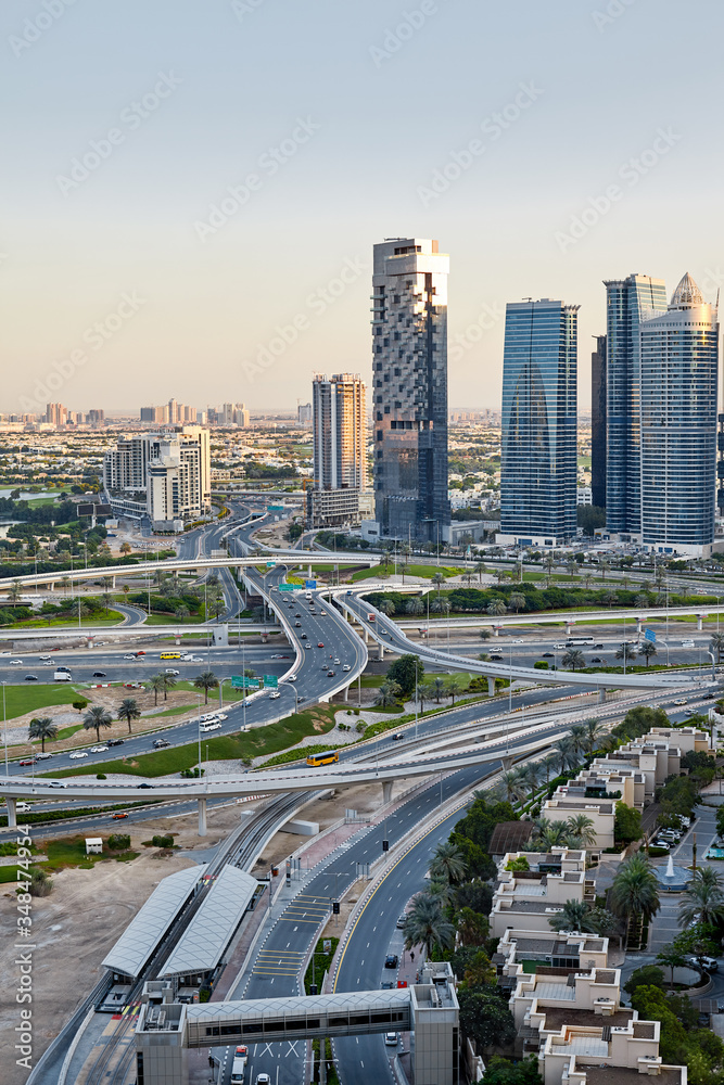 Fototapeta premium View of a road junction with moving cars on the background of a modern city