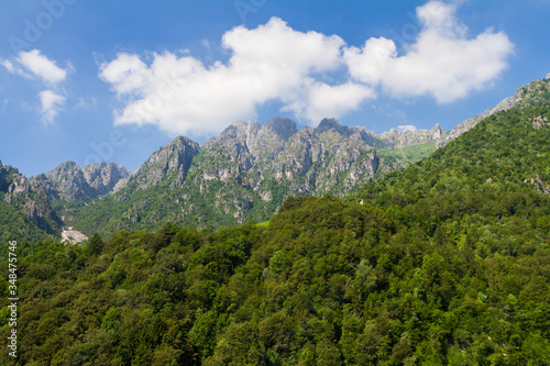 View of a sunny day on Italian Alps in summer time. Blue sky over the panorama