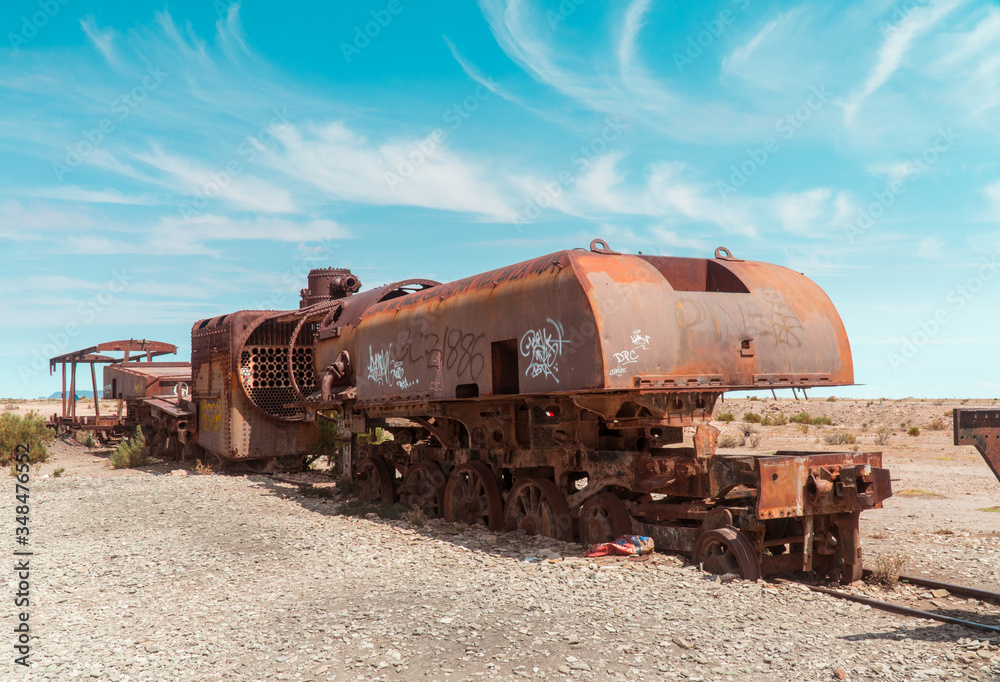 Train Cemetry Bolivia Salt Flats. Bolivian salty desert and blue sky background. Shot in Salar de Uyuni. Rusted, waste, abandoned, locomotive graveyard, railroad concepts. Tourist attraction Train Cemetry Bolivia Salt Flats. Bolivian salty desert and blue sky background. Shot in Salar de Uyuni. Rusted, waste, abandoned, locomotive graveyard, railroad concepts. Tourist attraction