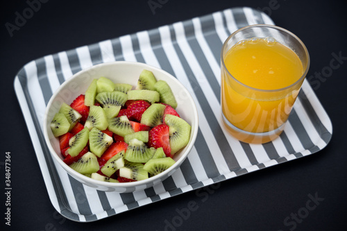Delicious breakfast consisting of strawberries, kiwi and orange juice