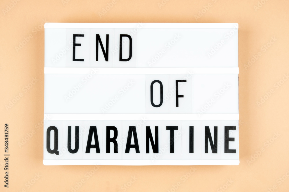 Light box with the inscription END of QUARANTINE on a beige background Light box with the inscription END of QUARANTINE on a beige background