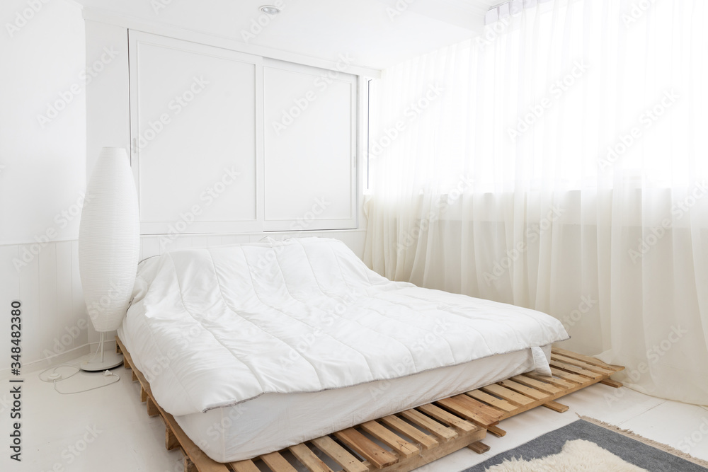 Φωτογραφία interior view of white bed on a wooden plank in the morning with curtain and sun