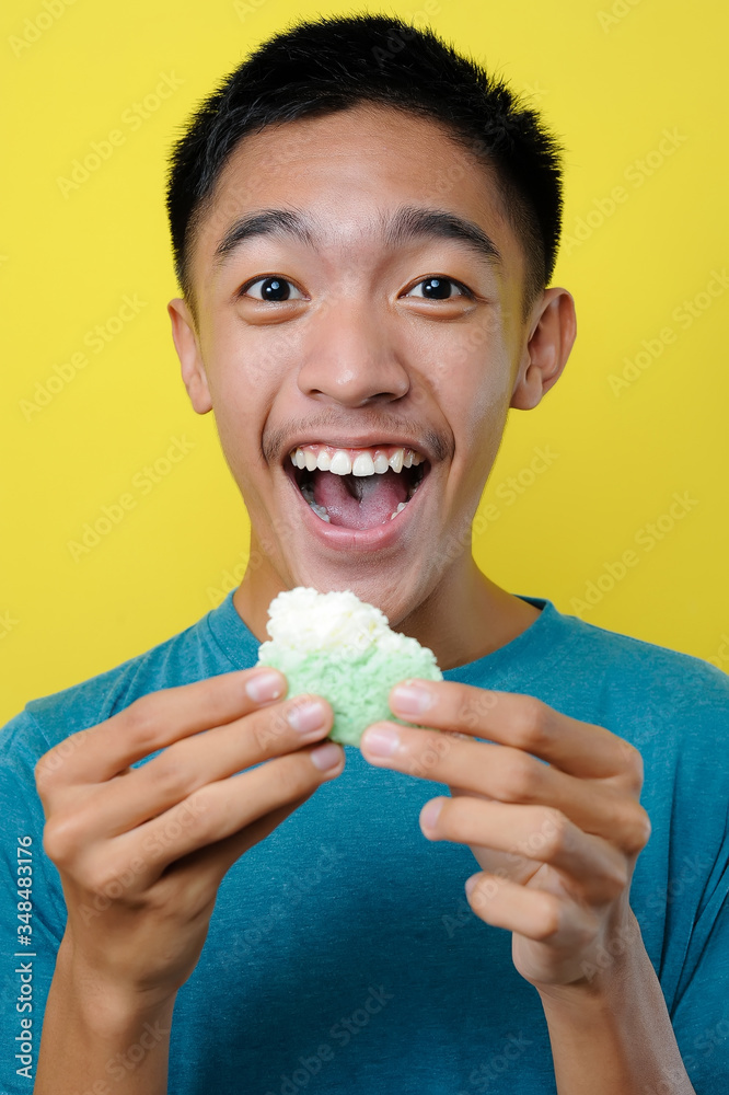 Happy Excited Young Asian man eating cake Happy Excited Young Asian man eating cake