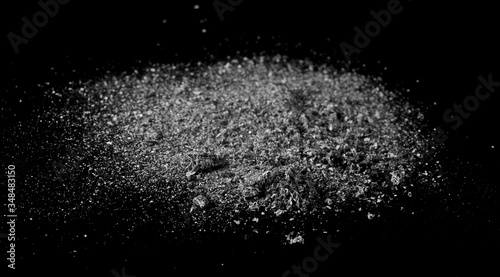 Cigarette ash pile isolated on black background, texture
