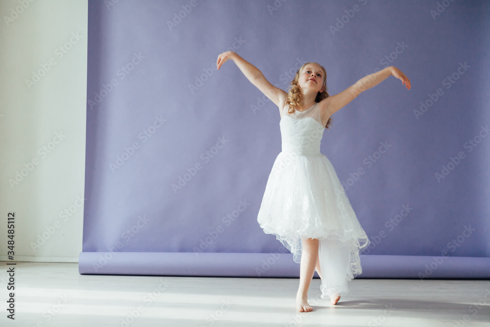 Beautiful little girl in dress dances alone at home Beautiful little girl in dress dances alone at home