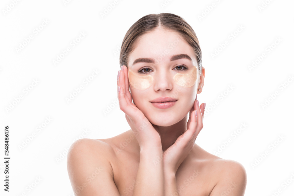 Close-up of a young woman with patches under eyes from wrinkles and dark circles isolated on white background Close-up of a young woman with patches under eyes from wrinkles and dark circles isolated on white background