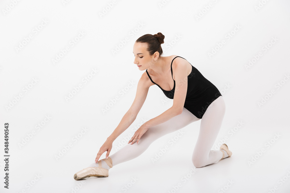 Image of caucasian woman ballerina practicing and stretching her body