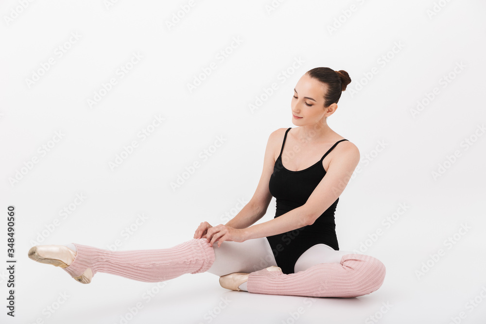 Fototapeta premium Image of caucasian woman ballerina practicing and stretching her body