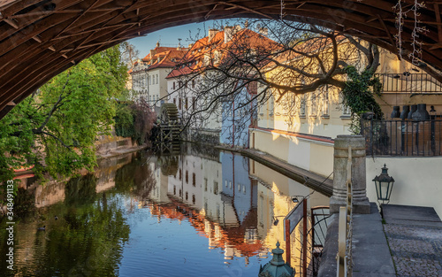 View under the arch of the Charles Bridge on the Certovka water wheel. Prague. photo