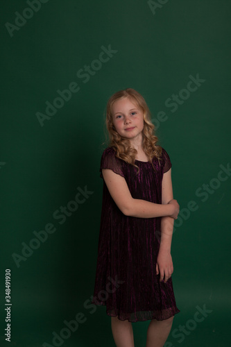 Portrait of a beautiful little blonde girl in a dark dress © dmitriisimakov