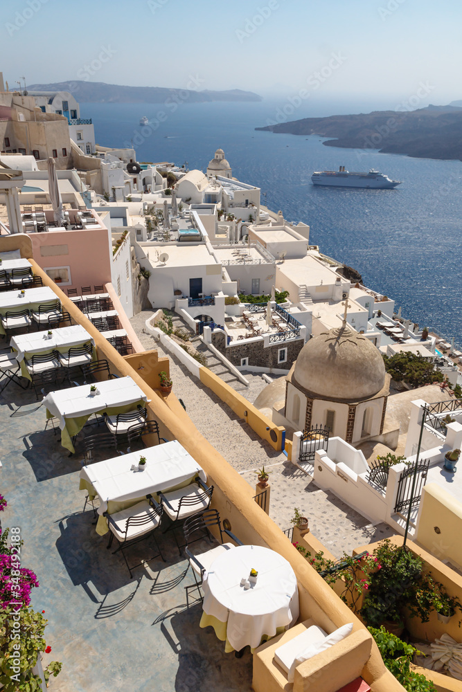Empty terrace of a restaurant with overview over city and seaside, Fira, Santorini, Greece